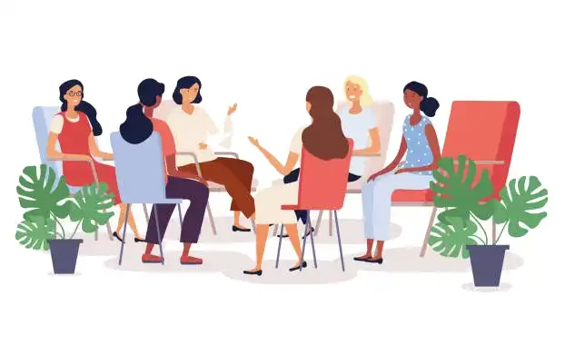 A group of women sitting in chair discussing in MLM party